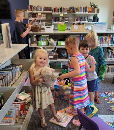 Toddlers examining books at the Maggie Osgood Library